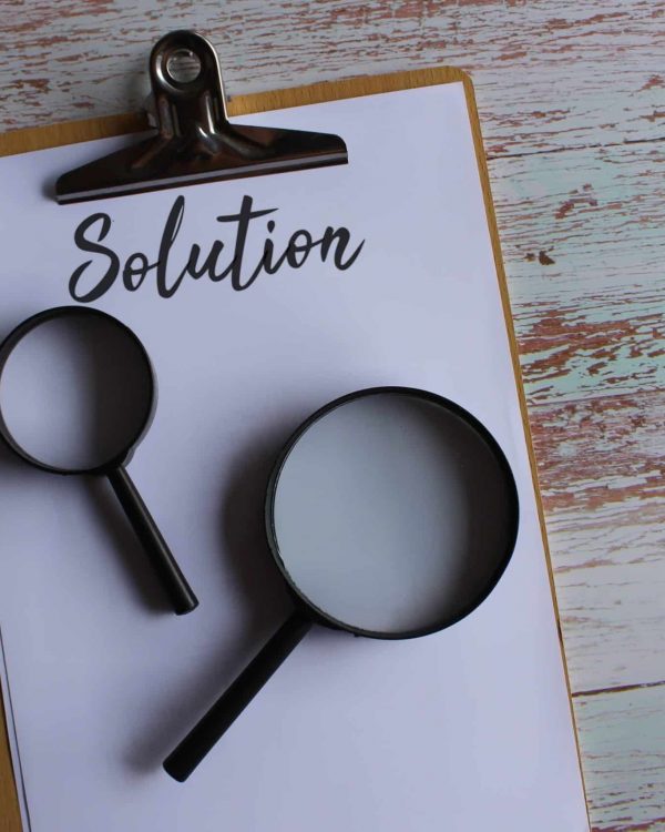 Searching for solution, finding solution concept. Magnifying glass and text SOLUTION.